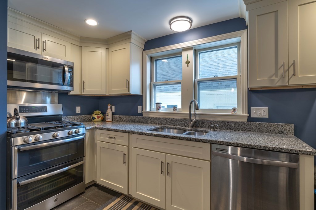 197 Bridge Road Northampton, MA 01062 - Photo 6 of 24 a kitchen with stainless steel appliances granite countertop a stove a sink and a microwave