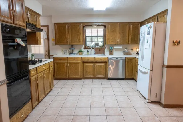 a kitchen with a stove top oven sink and cabinets