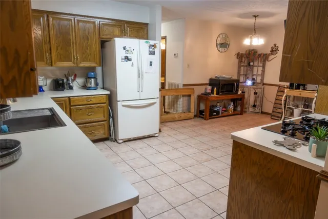 a kitchen with refrigerator and cabinets