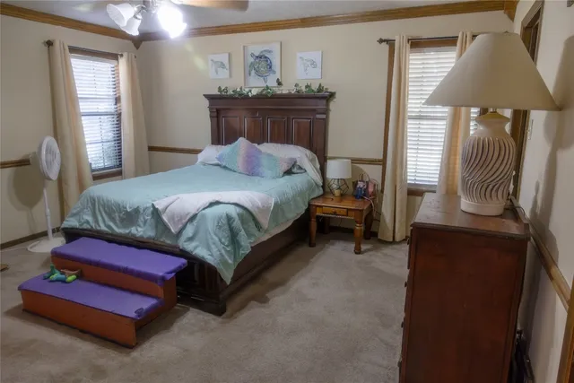 a bedroom with a bed and a chandelier