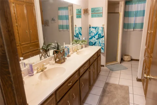 a bathroom with a double vanity sink and a mirror