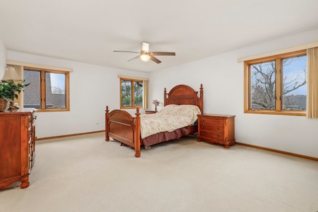 780 94th Street Burr Ridge, IL 60527 - Photo 20 of 53 a spacious bedroom with a bed and a large window