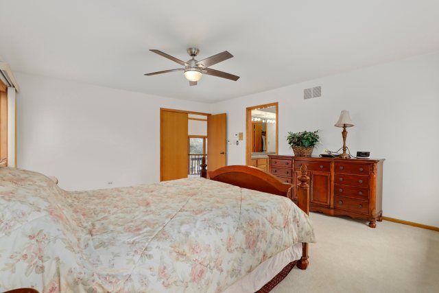 780 94th Street Burr Ridge, IL 60527 - Photo 22 of 53 a bedroom with a large bed and dresser
