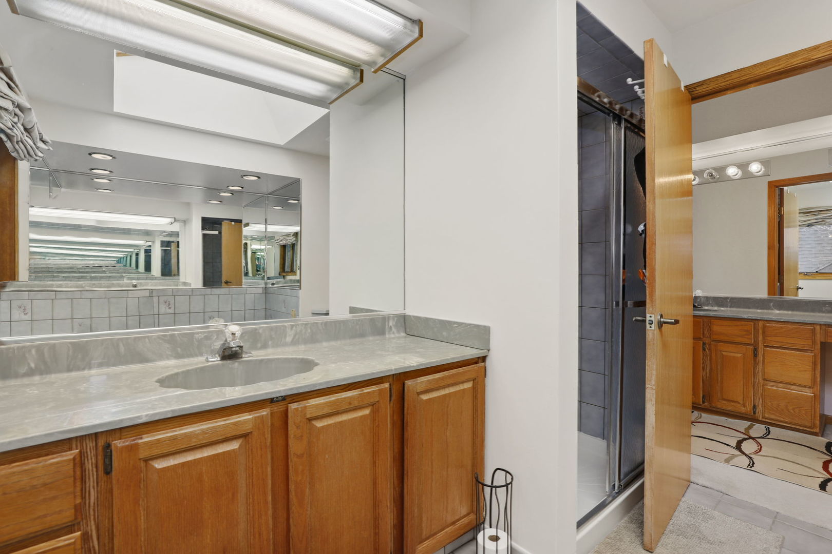 780 94th Street Burr Ridge, IL 60527 - Photo 25 of 53 a bathroom with a granite countertop sink and a mirror