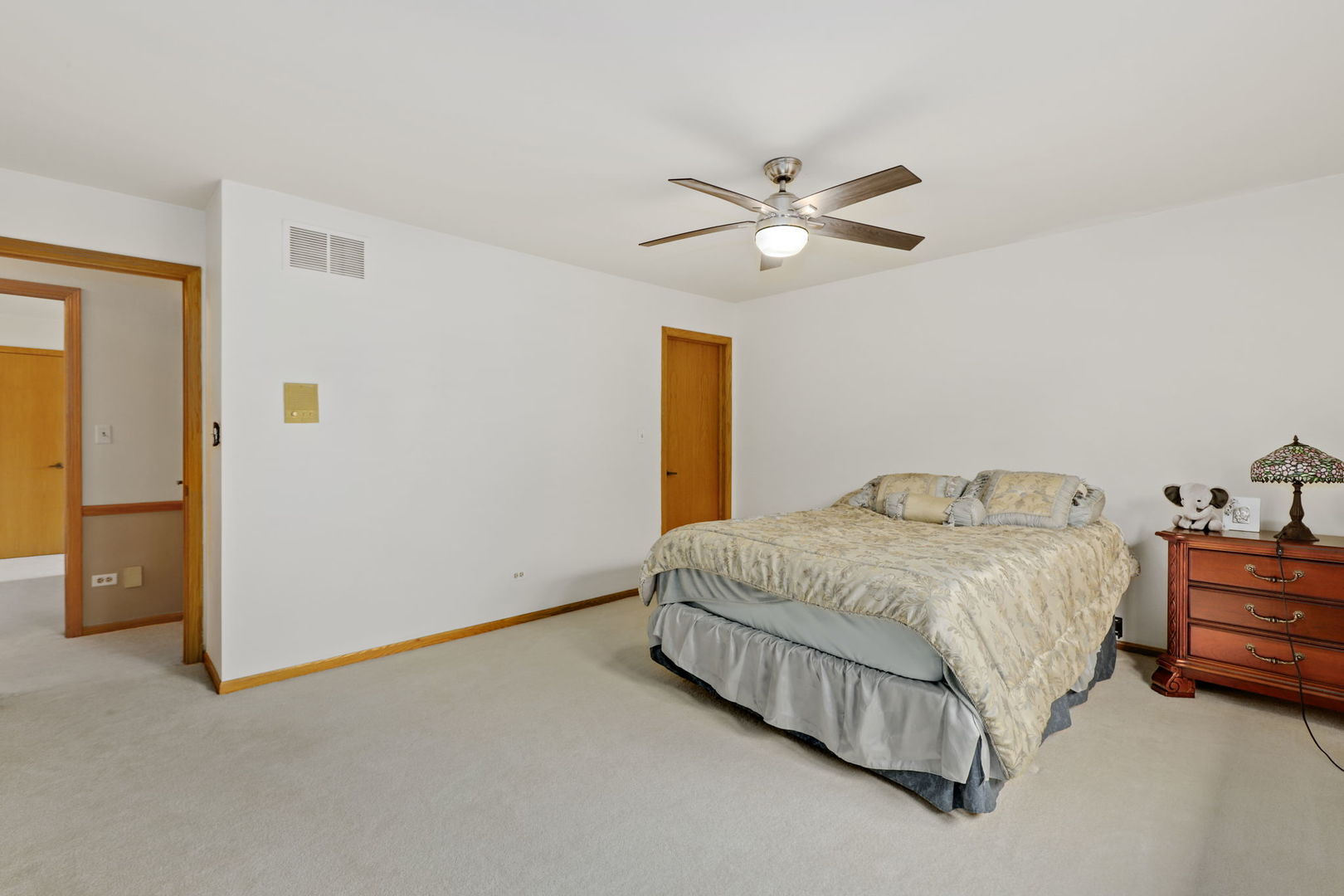 780 94th Street Burr Ridge, IL 60527 - Photo 29 of 53 a bedroom with a bed and a chandelier