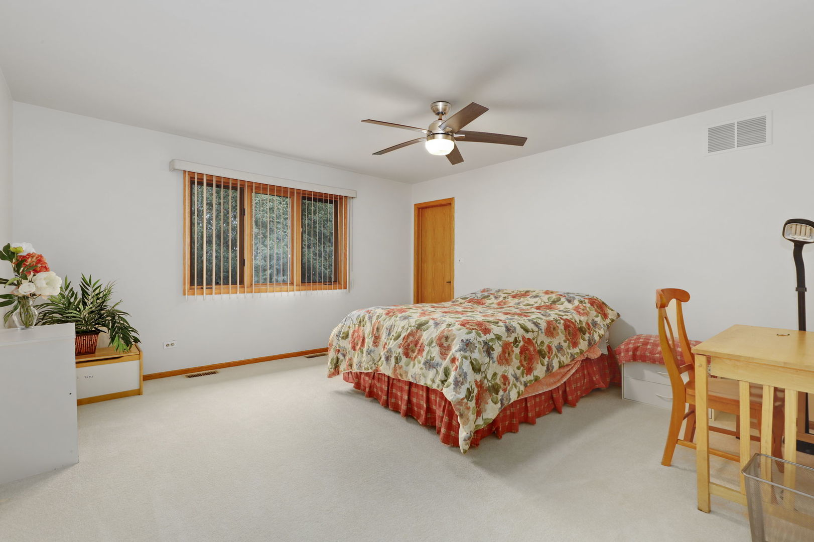 780 94th Street Burr Ridge, IL 60527 - Photo 30 of 53 a bedroom with a bed and a chandelier