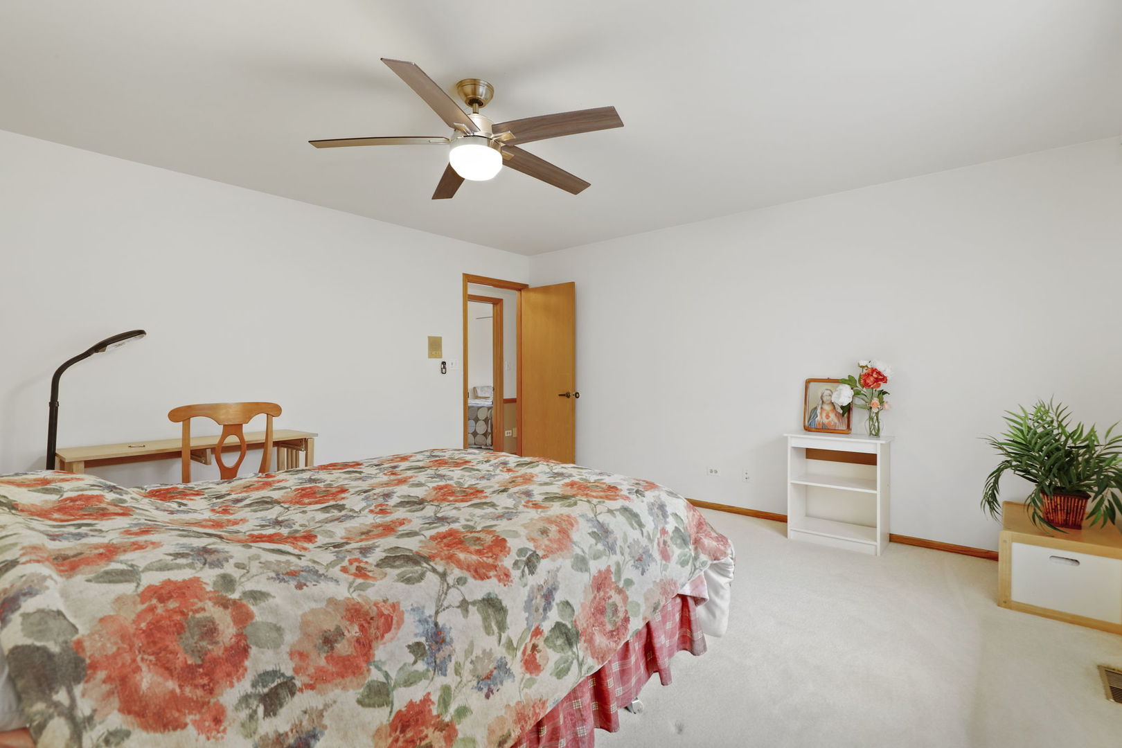 780 94th Street Burr Ridge, IL 60527 - Photo 31 of 53 a bedroom with a bed and a chandelier