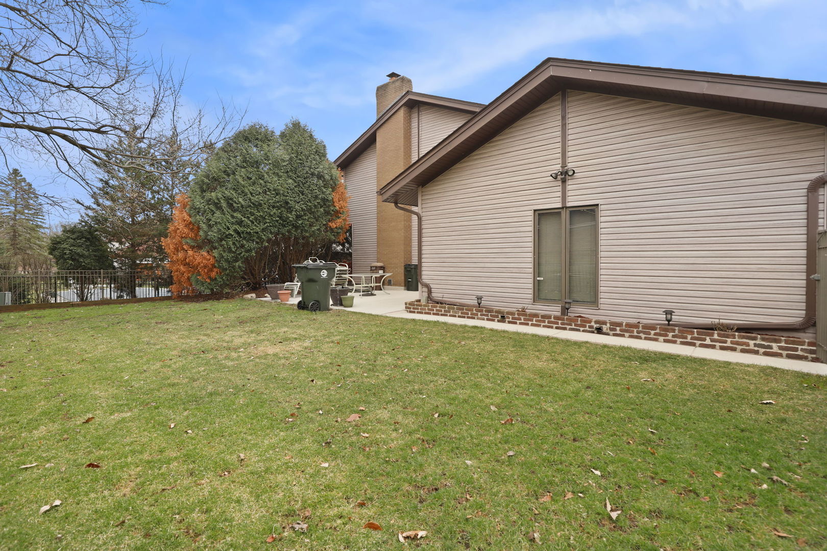780 94th Street Burr Ridge, IL 60527 - Photo 49 of 53 a backyard of a house with plants and trees