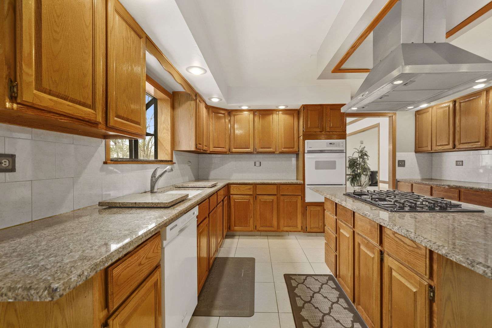 780 94th Street Burr Ridge, IL 60527 - Photo 8 of 53 a kitchen with stainless steel appliances granite countertop a sink a stove and a wooden cabinets