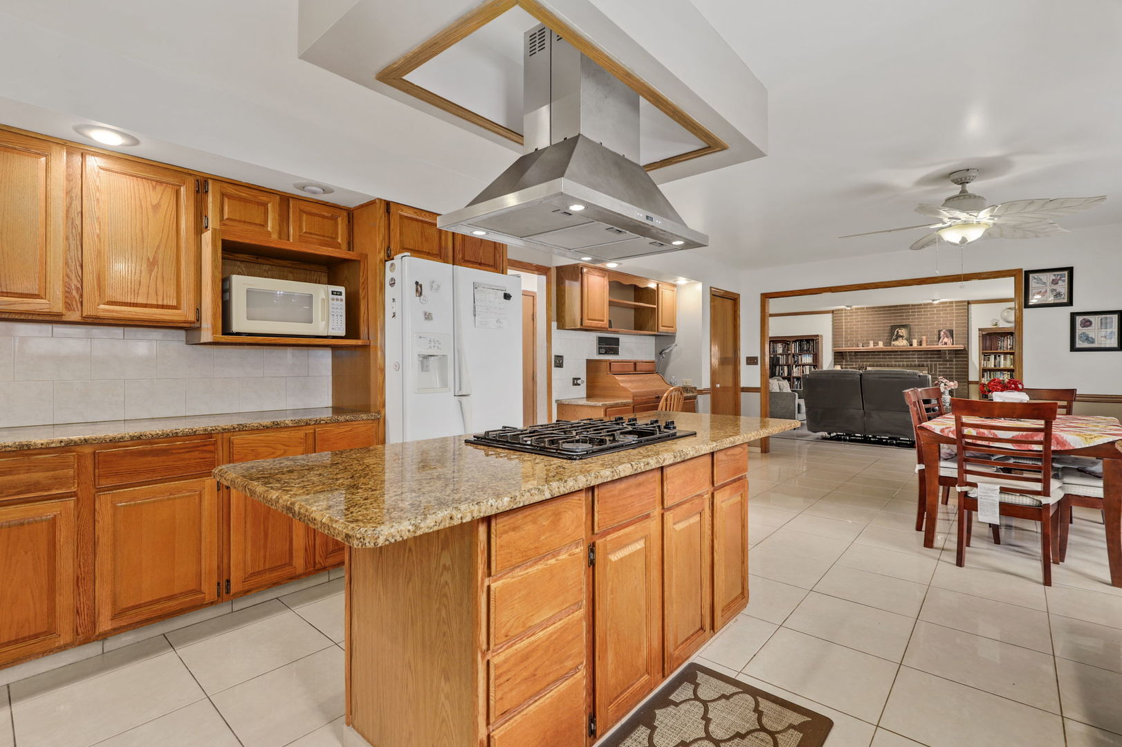 780 94th Street Burr Ridge, IL 60527 - Photo 10 of 53 a kitchen with stainless steel appliances granite countertop dining table chairs cabinets and a sink