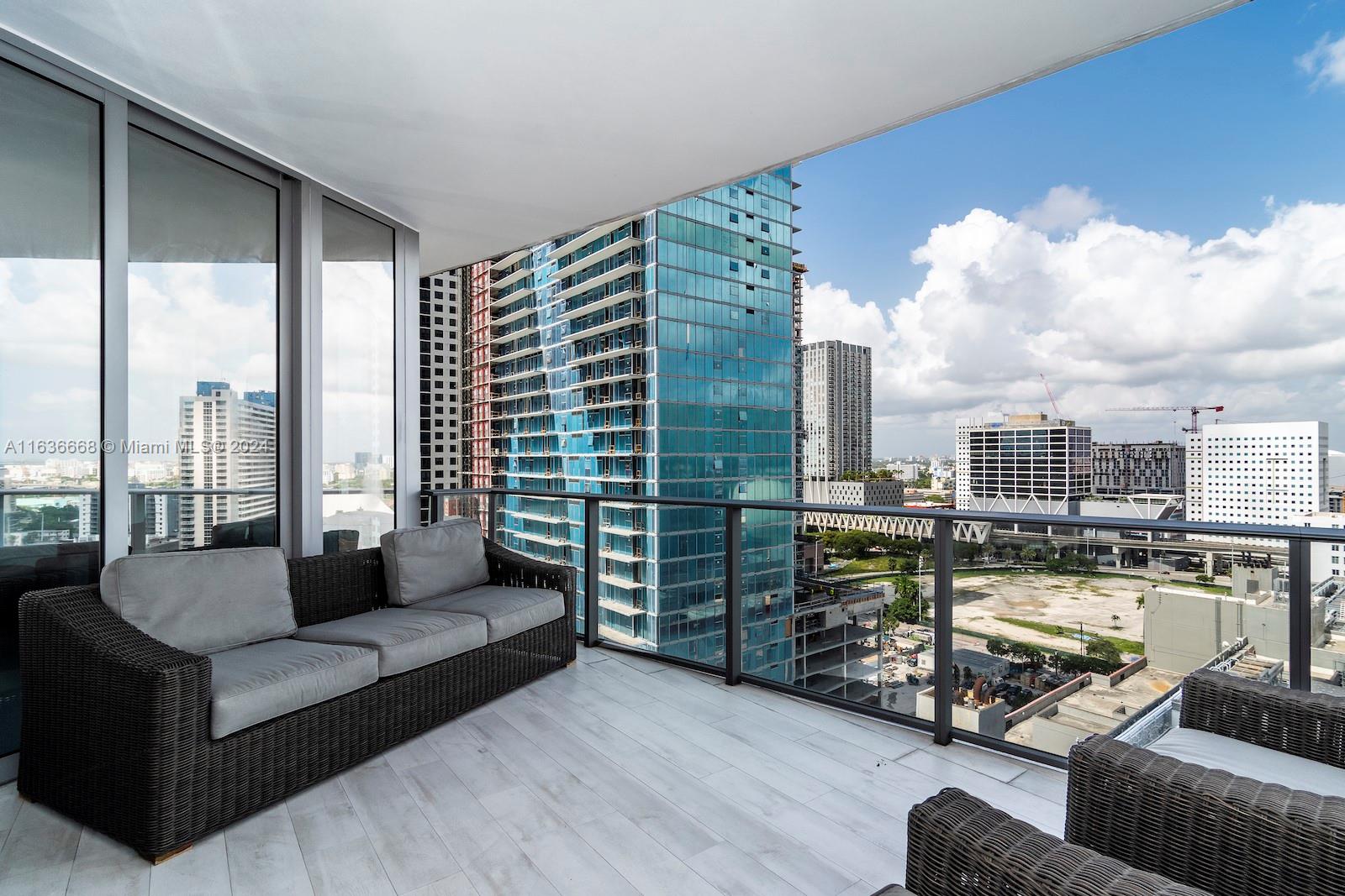 851 Northeast 1st Avenue, Unit 1710 Miami, FL 33132 - Photo 3 of 26 a living room with furniture and a large window