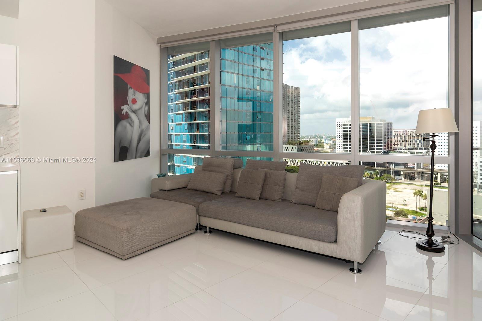 851 Northeast 1st Avenue, Unit 1710 Miami, FL 33132 - Photo 4 of 26 a living room with furniture and a floor to ceiling window
