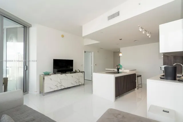 a kitchen with a sink cabinets and wooden floor