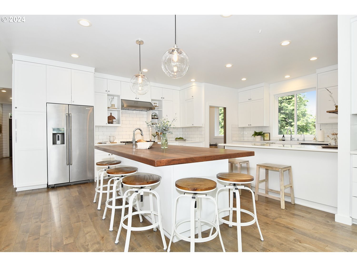 774 Southeast 25th Street Gresham, OR 97080 - Photo 11 of 39 a kitchen with stainless steel appliances kitchen island granite countertop a dining table chairs and white cabinets