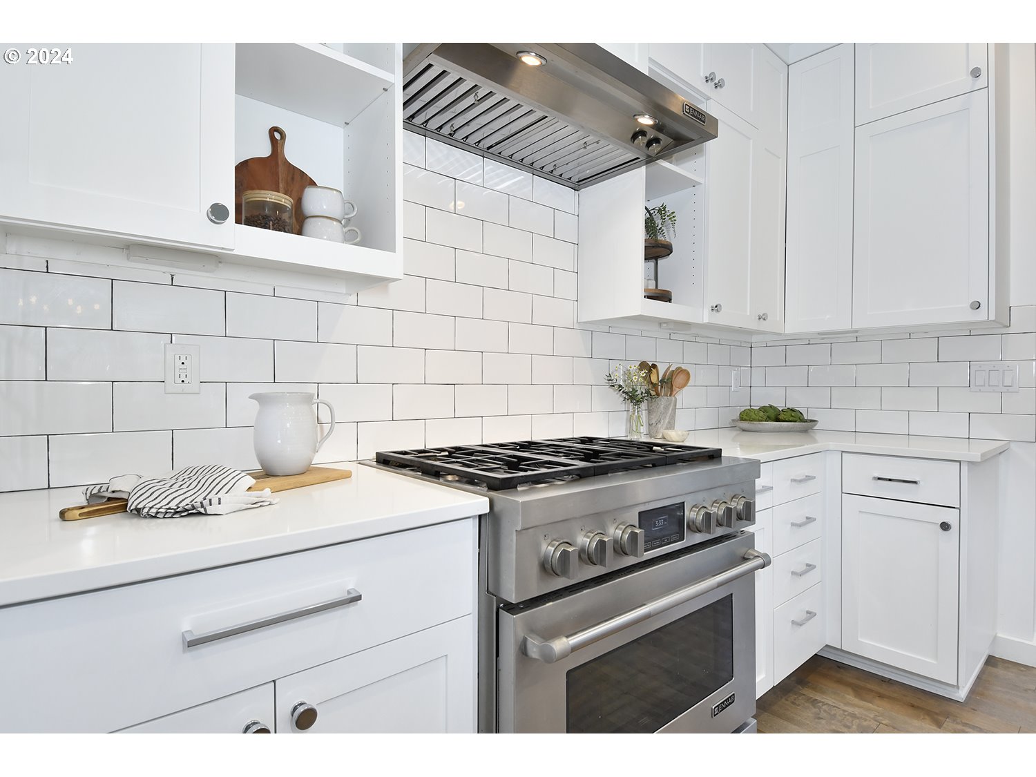 774 Southeast 25th Street Gresham, OR 97080 - Photo 13 of 39 a kitchen with a stove cabinets and wooden floor