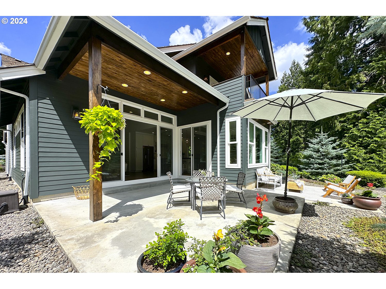 774 Southeast 25th Street Gresham, OR 97080 - Photo 32 of 39 a view of a patio with table and chairs under an umbrella with a small yard
