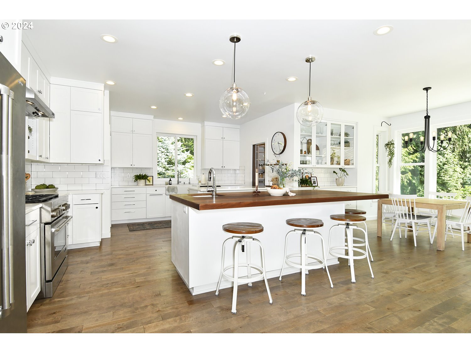 774 Southeast 25th Street Gresham, OR 97080 - Photo 9 of 39 a kitchen with kitchen island granite countertop a table chairs a sink dishwasher window and cabinets