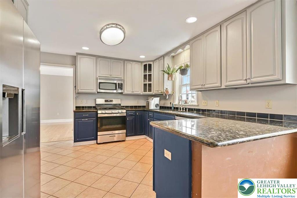 18 Cub Lane Jim Thorpe, PA 18229 - Photo 29 of 58 a kitchen with stainless steel appliances granite countertop a stove a sink and a microwave