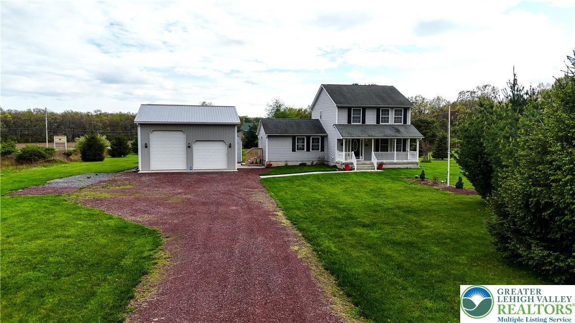 18 Cub Lane Jim Thorpe, PA 18229 - Photo 3 of 58 a front view of a house with garden and trees