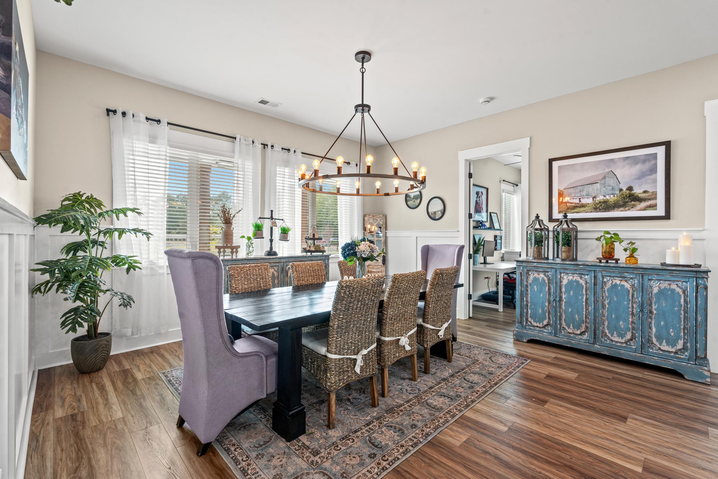 411 Chamberlin Road Myrtle Beach, SC 29588 - Photo 11 of 40 Dining space with wainscoting, a decorative wall, dark wood-style floors, and a chandelier