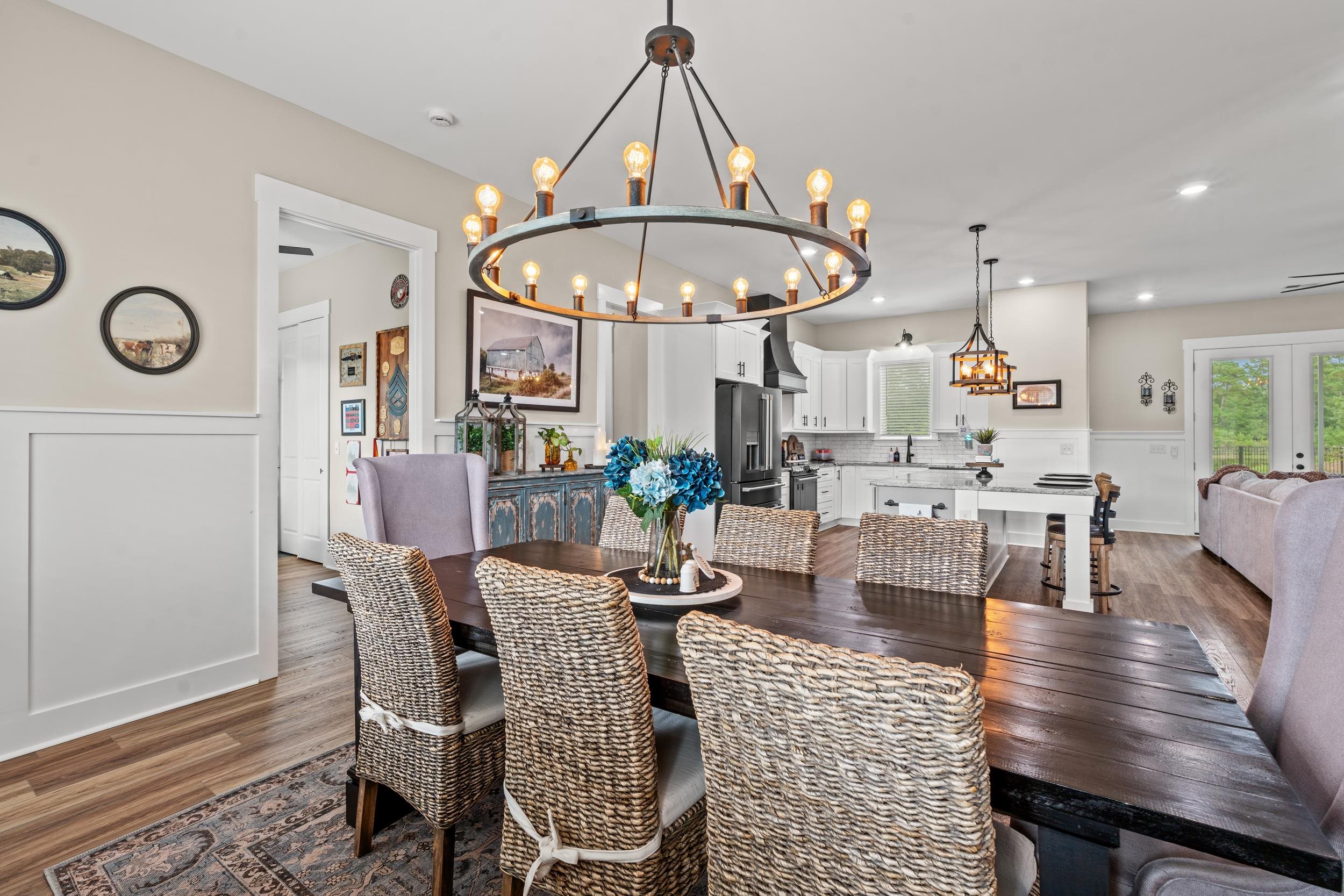 411 Chamberlin Road Myrtle Beach, SC 29588 - Photo 13 of 40 Dining room with wainscoting, a decorative wall, dark wood finished floors, french doors, and a chandelier