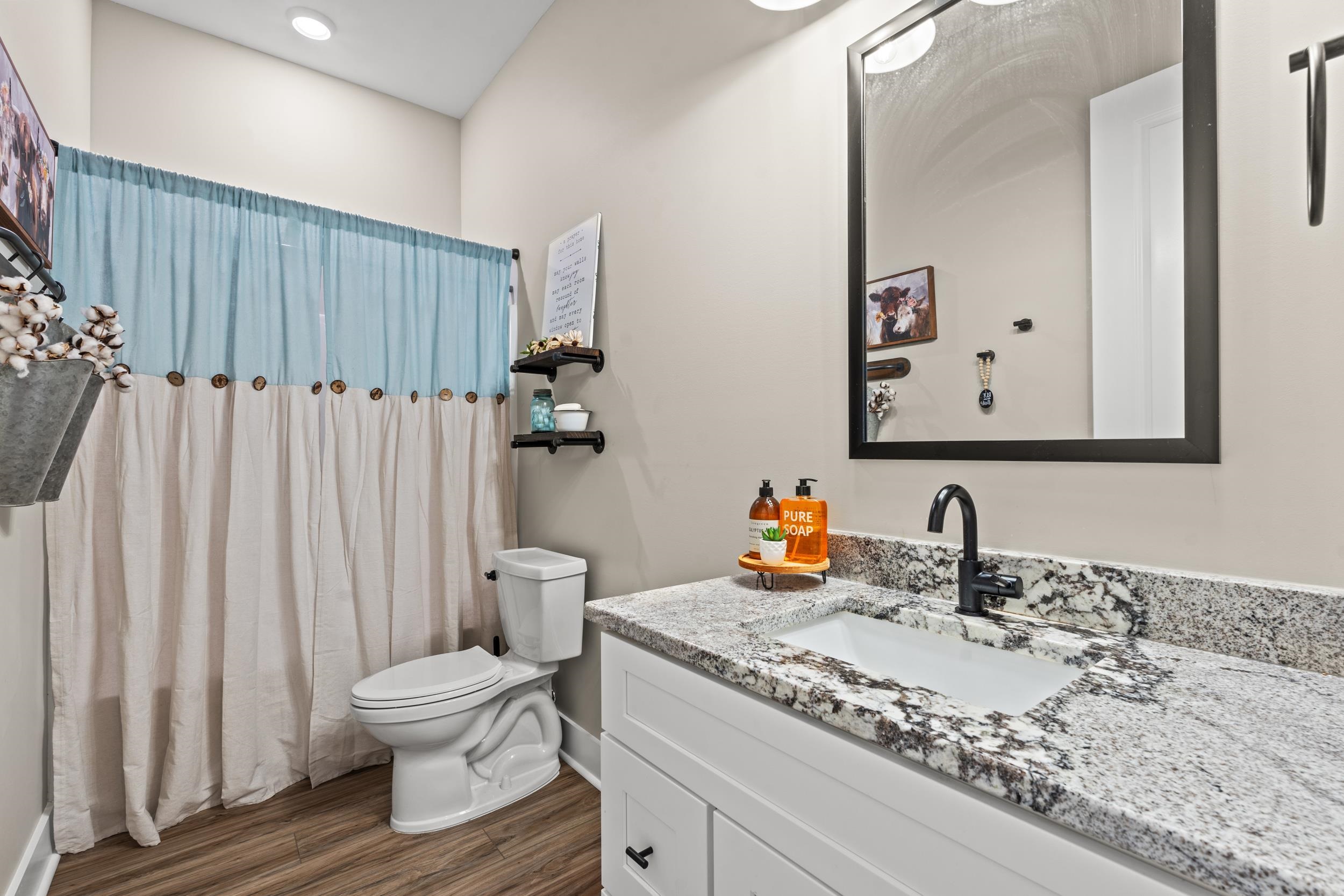 411 Chamberlin Road Myrtle Beach, SC 29588 - Photo 14 of 40 Bathroom featuring a shower with curtain, vanity, and dark wood finished floors