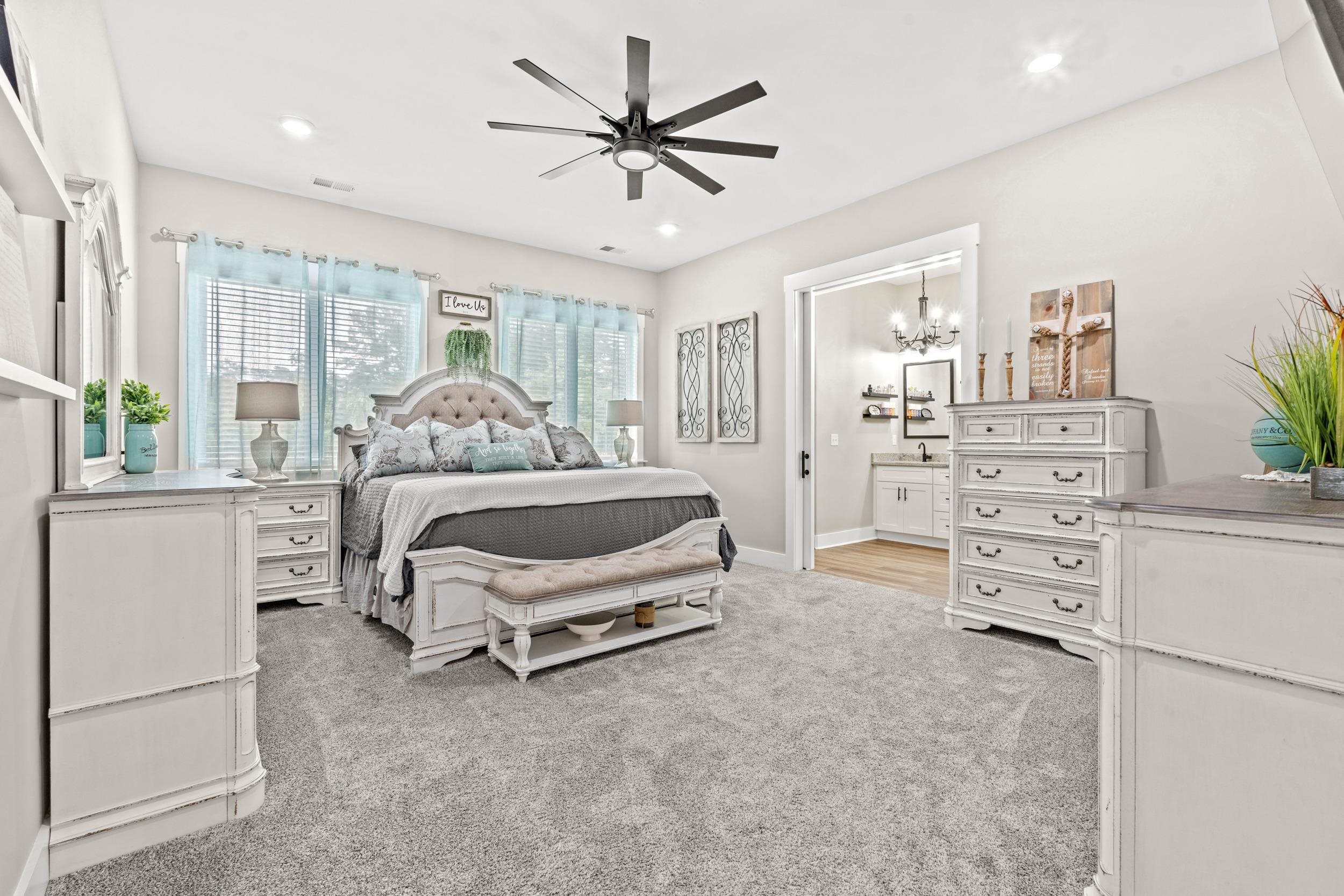 411 Chamberlin Road Myrtle Beach, SC 29588 - Photo 17 of 40 Bedroom with light carpet, ceiling fan, ensuite bathroom, and a chandelier