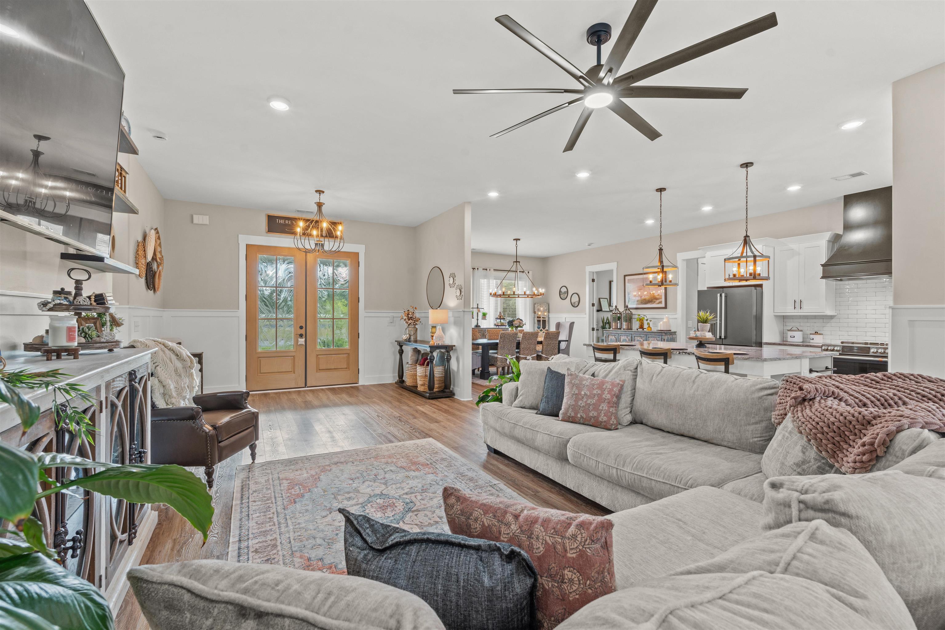 411 Chamberlin Road Myrtle Beach, SC 29588 - Photo 3 of 40 Living area featuring a chandelier, wood finished floors, ceiling fan, wainscoting, and recessed lighting