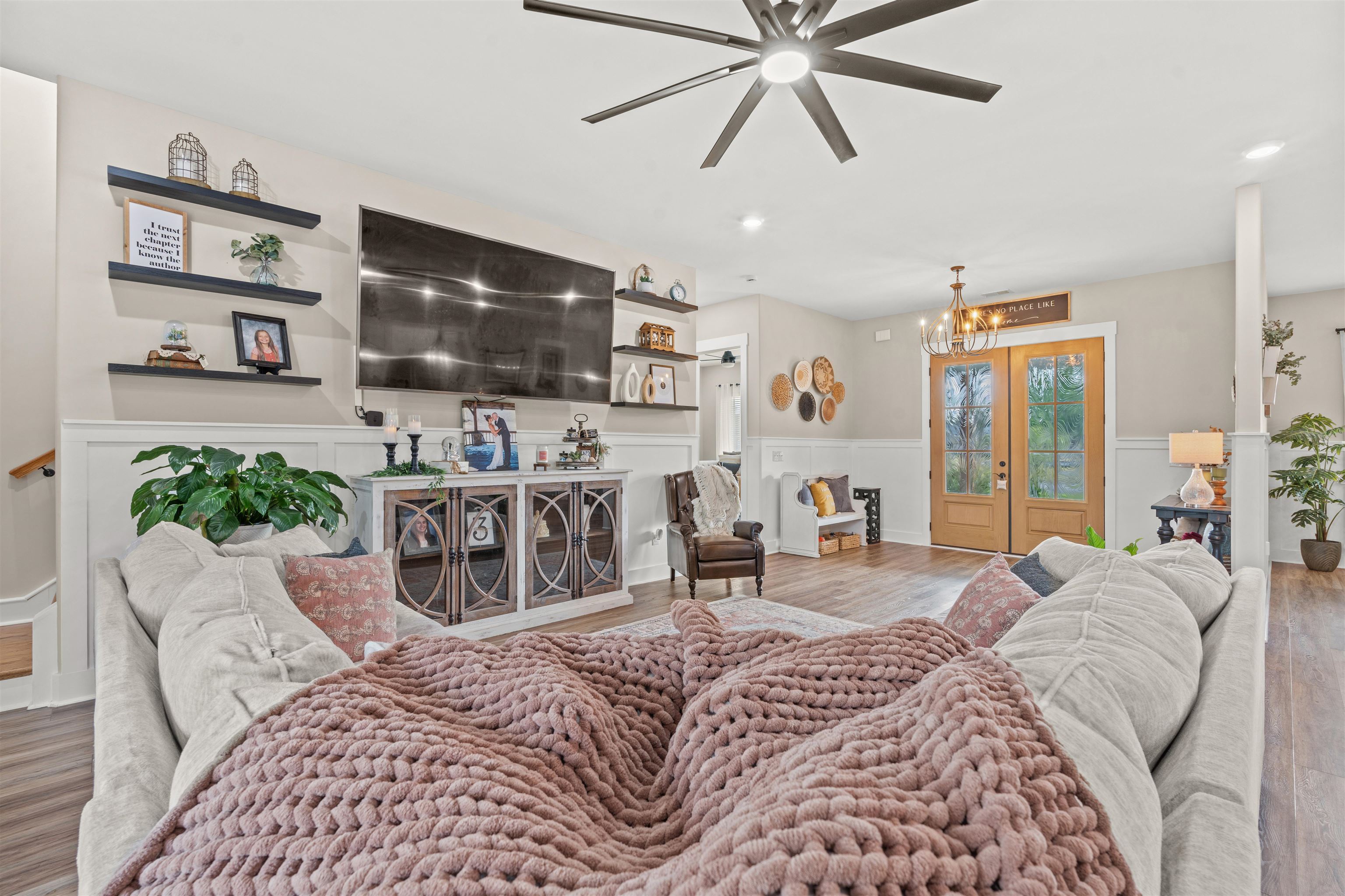 411 Chamberlin Road Myrtle Beach, SC 29588 - Photo 4 of 40 Living area with wood finished floors, a chandelier, ceiling fan, and wainscoting