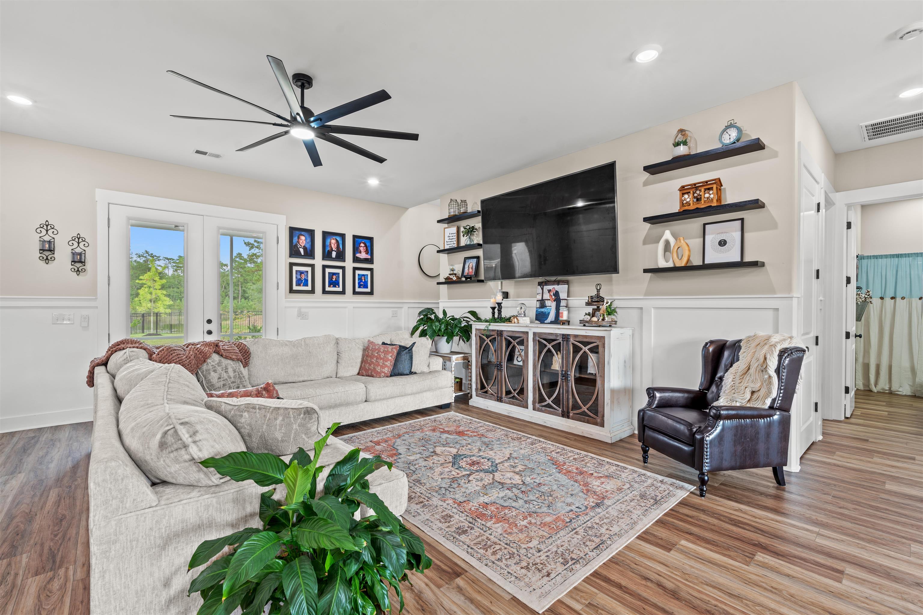 411 Chamberlin Road Myrtle Beach, SC 29588 - Photo 6 of 40 Living area featuring wood finished floors, a wainscoted wall, french doors, ceiling fan, and a decorative wall