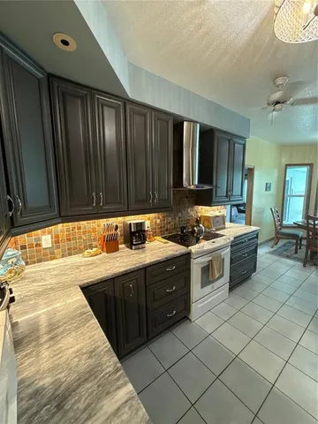 a kitchen with a stove sink and cabinets