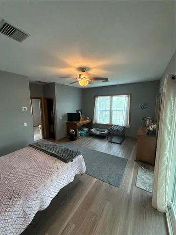 a bedroom with a large bed and a large window