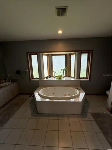 a living room with a bathtub and a window