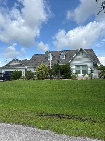 a view of an house with backyard space and garden