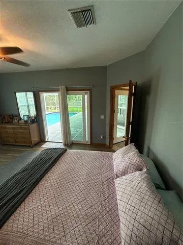 a bedroom with a large bed and a large window