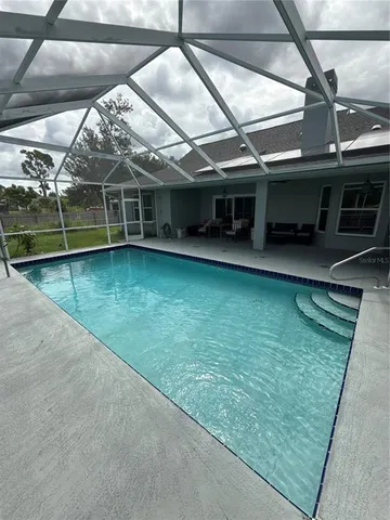 a view of a swimming pool with a yard
