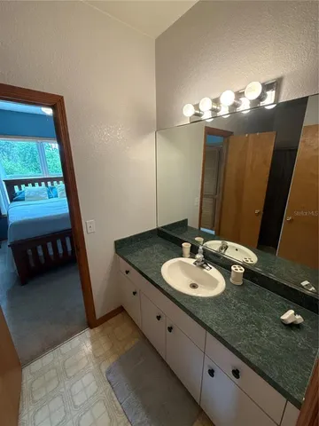 a bathroom with a double vanity sink and a mirror