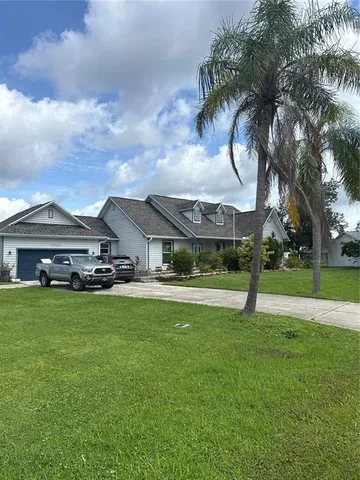 a front view of house with yard and mountain