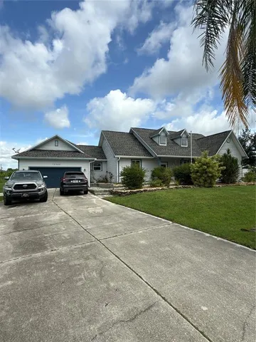 a car parked in front of a house with a yard