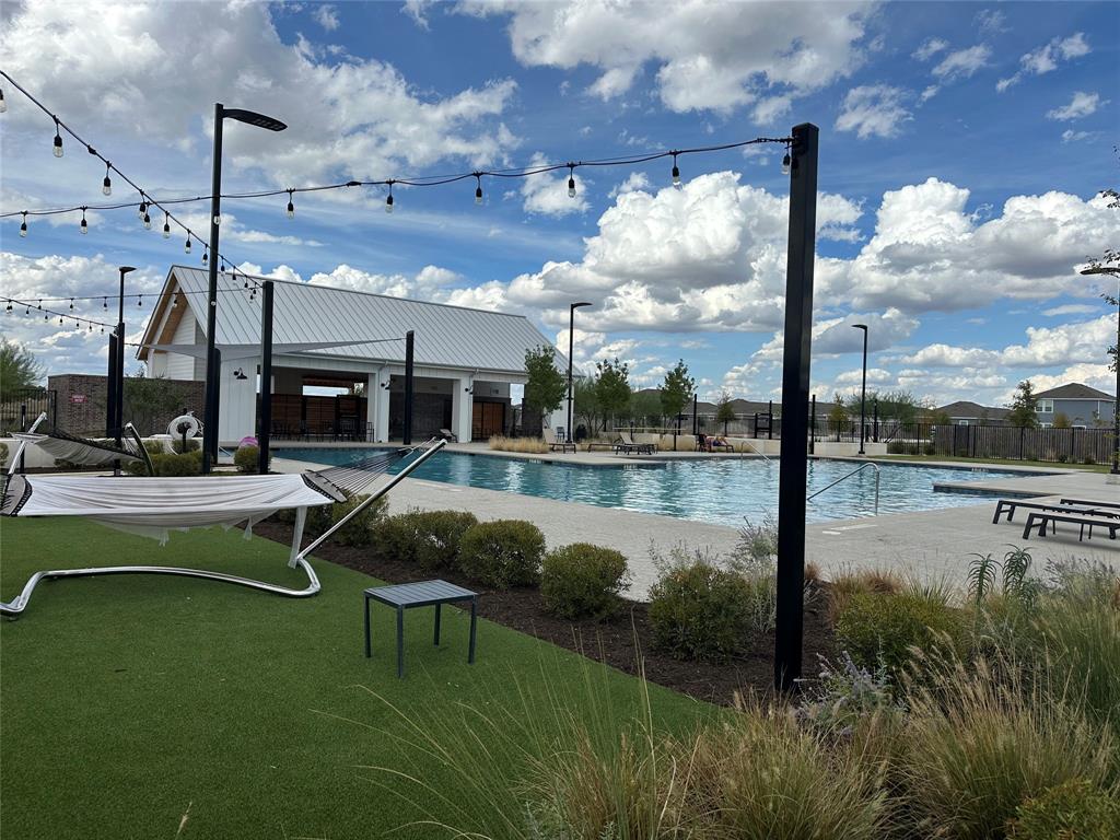 251 Tempest Trail Maxwell, TX 78656 - Photo 14 of 15 a swimming pool with outdoor seating and garden
