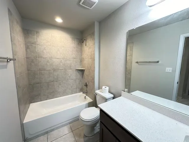 a bathroom with a sink a toilet and bathtub