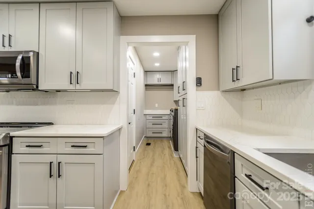 a kitchen with a refrigerator and a sink