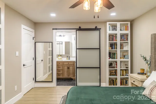 a bathroom with a sink toilet vanity and shower