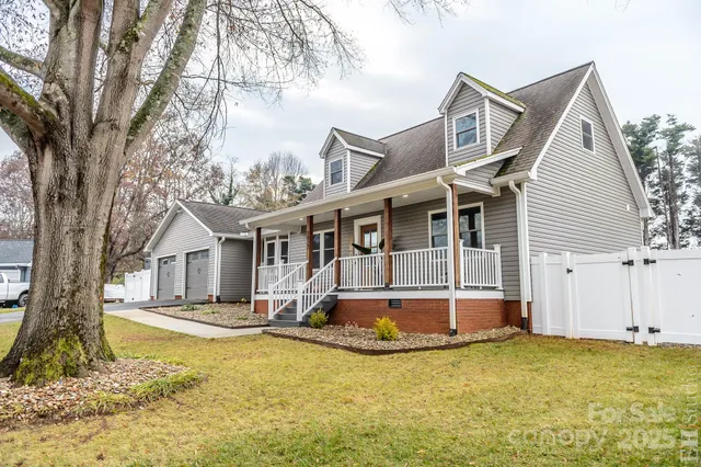 a front view of a house with a yard patio and swimming pool