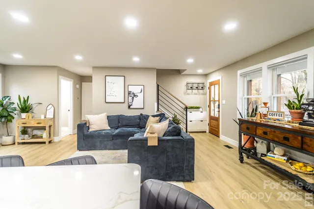 a living room with furniture and a wooden floor