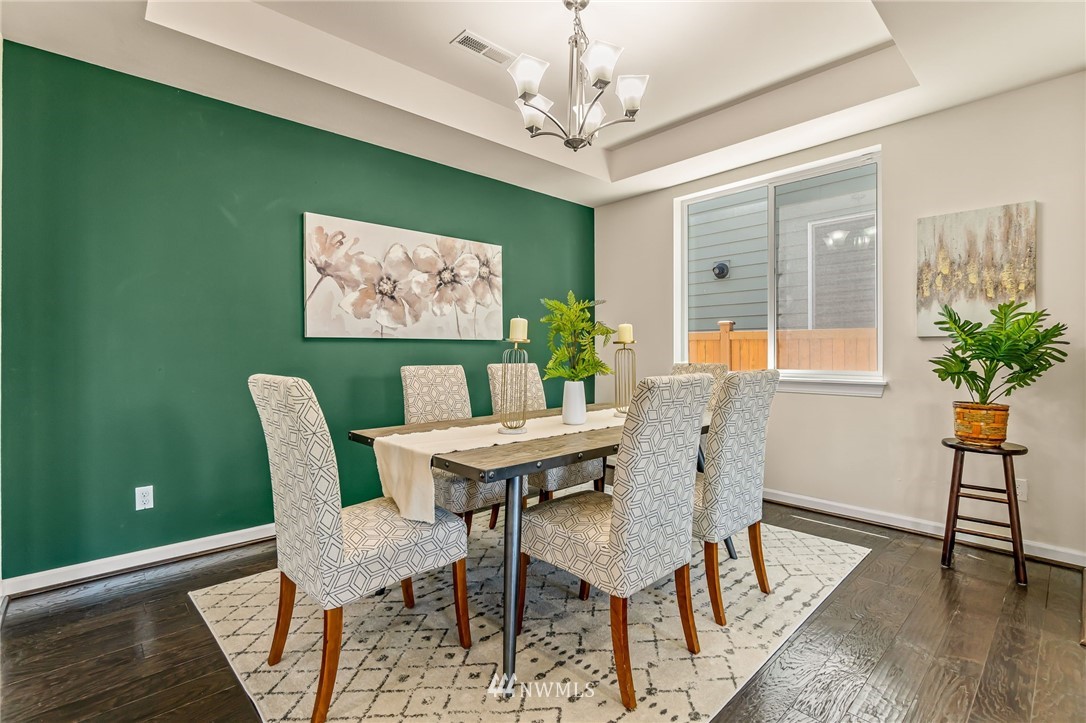 3527 198th Street Southeast Bothell, WA 98012 - Photo 19 of 40 a view of a dining room with furniture window and wooden floor