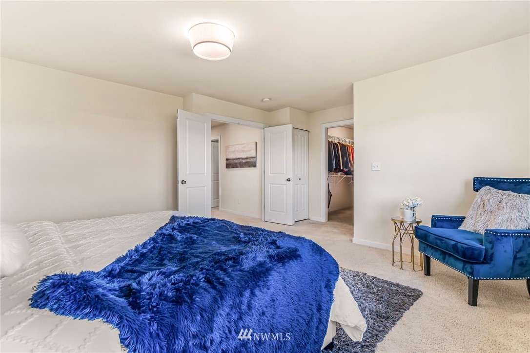 3527 198th Street Southeast Bothell, WA 98012 - Photo 25 of 40 a spacious bedroom with a bed and a chair