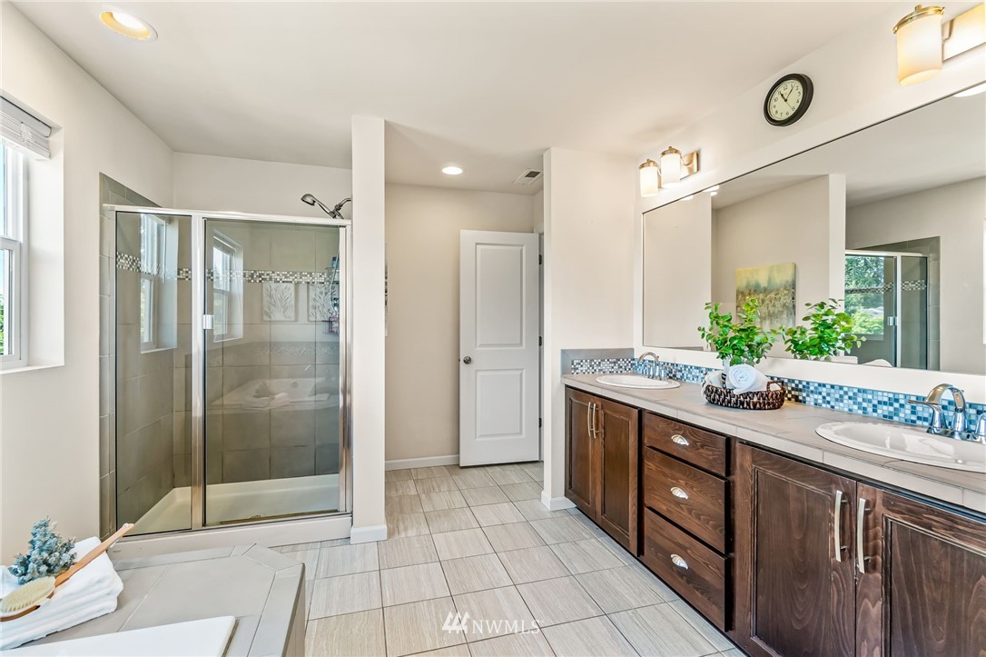 3527 198th Street Southeast Bothell, WA 98012 - Photo 26 of 40 a spacious bathroom with a granite countertop sink mirror and shower