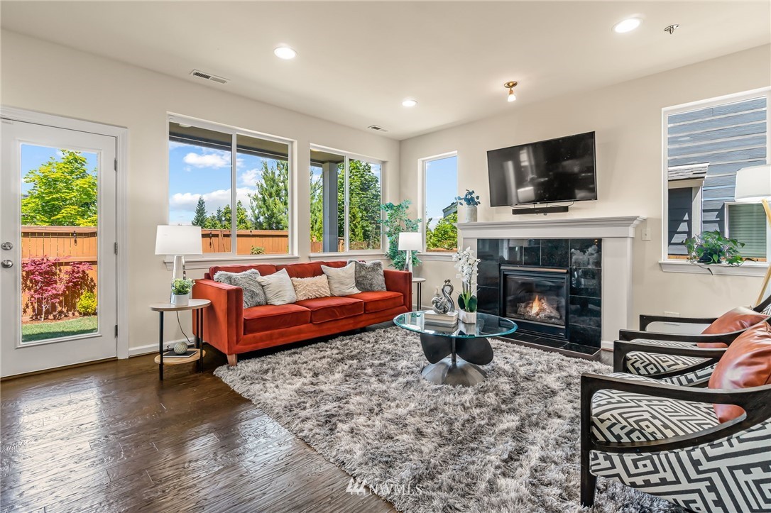 3527 198th Street Southeast Bothell, WA 98012 - Photo 6 of 40 a living room with furniture a flat screen tv and a fireplace