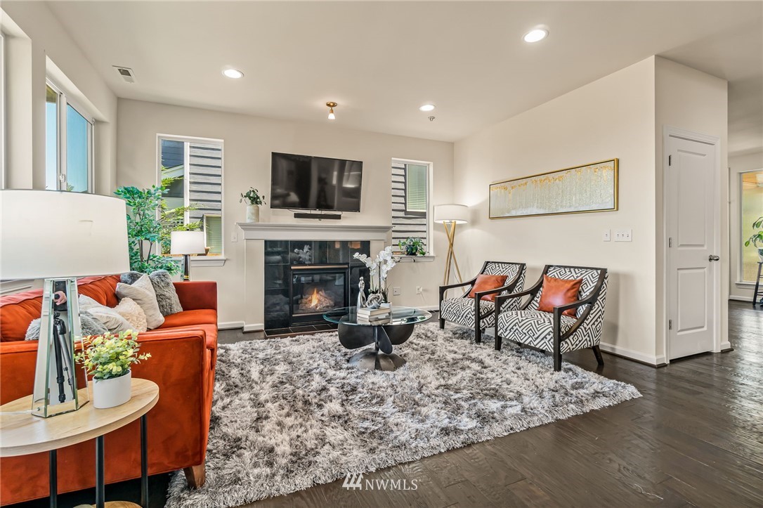 3527 198th Street Southeast Bothell, WA 98012 - Photo 8 of 40 a living room with furniture a fireplace and a flat screen tv